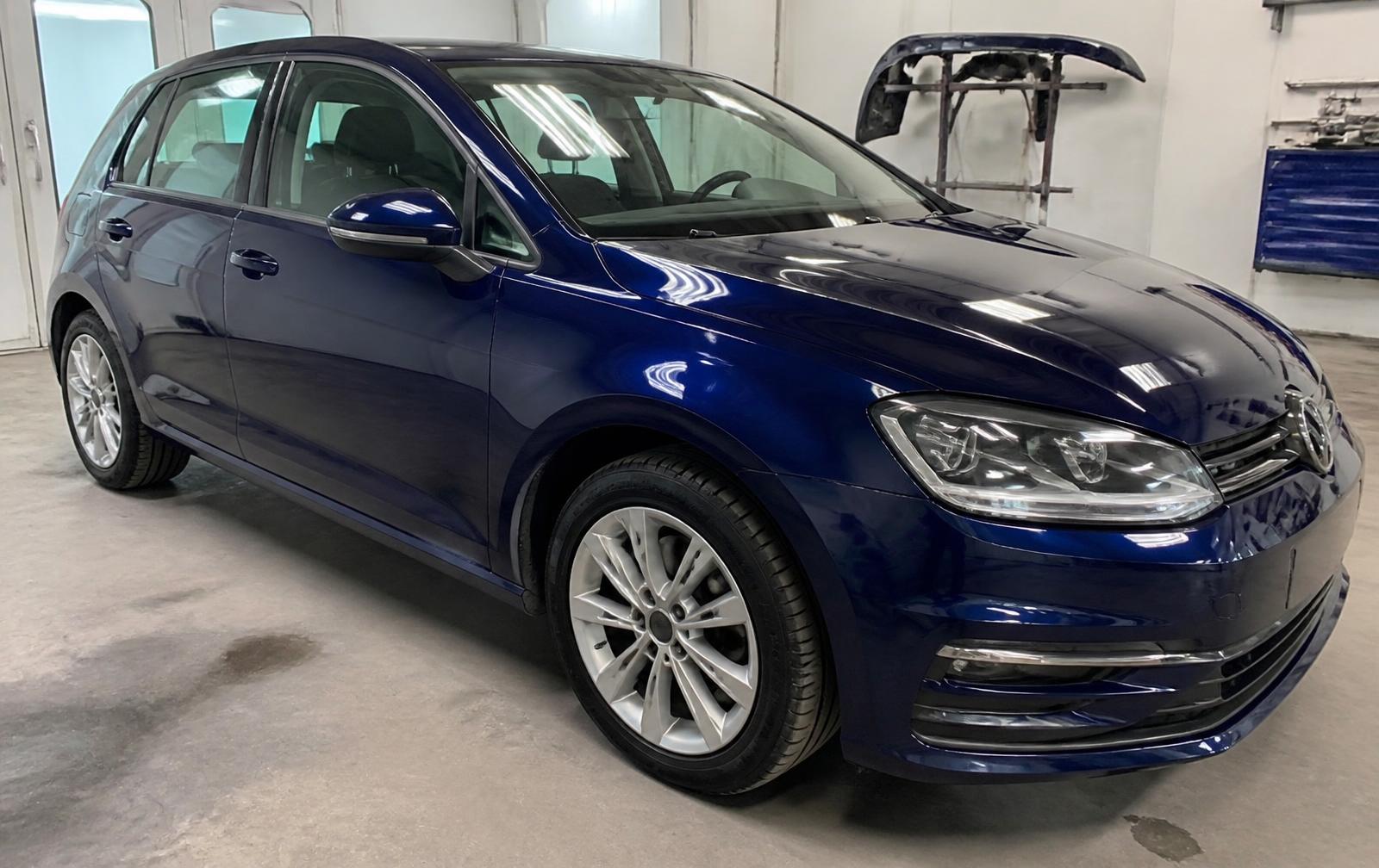 Blue Volkswagen Golf front bumper before and after accident repair — after