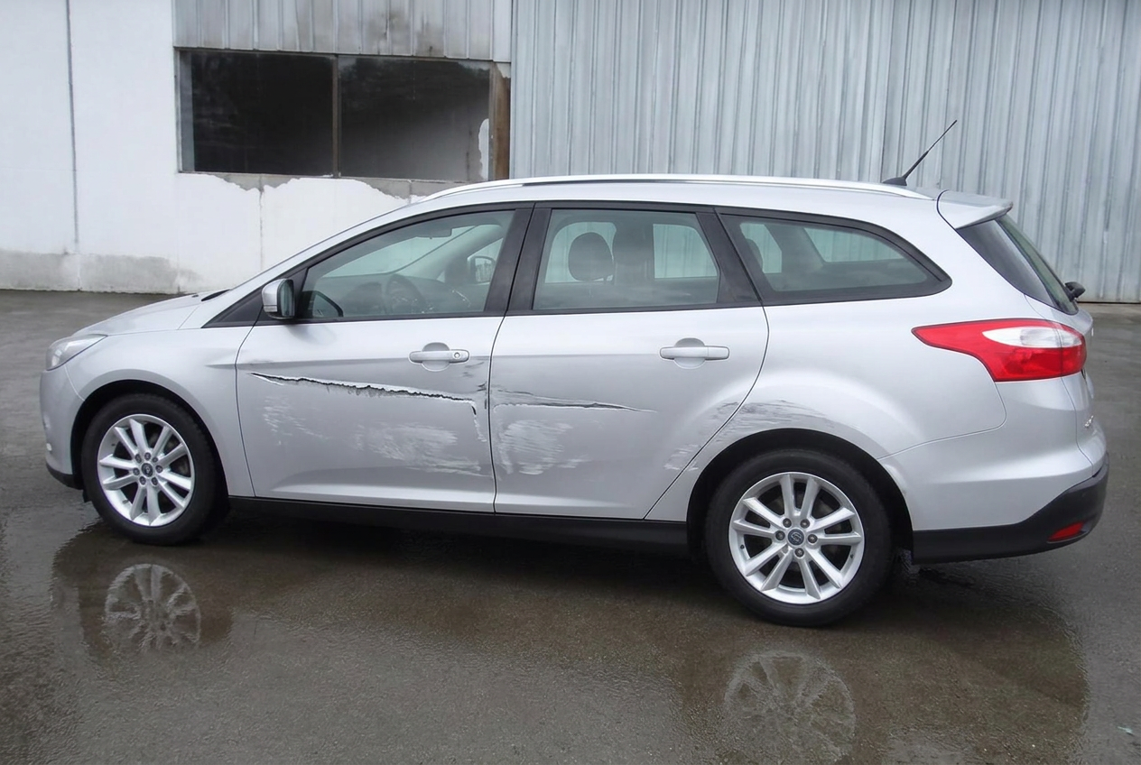 Silver Ford Focus estate doors before and after scratch repair — before